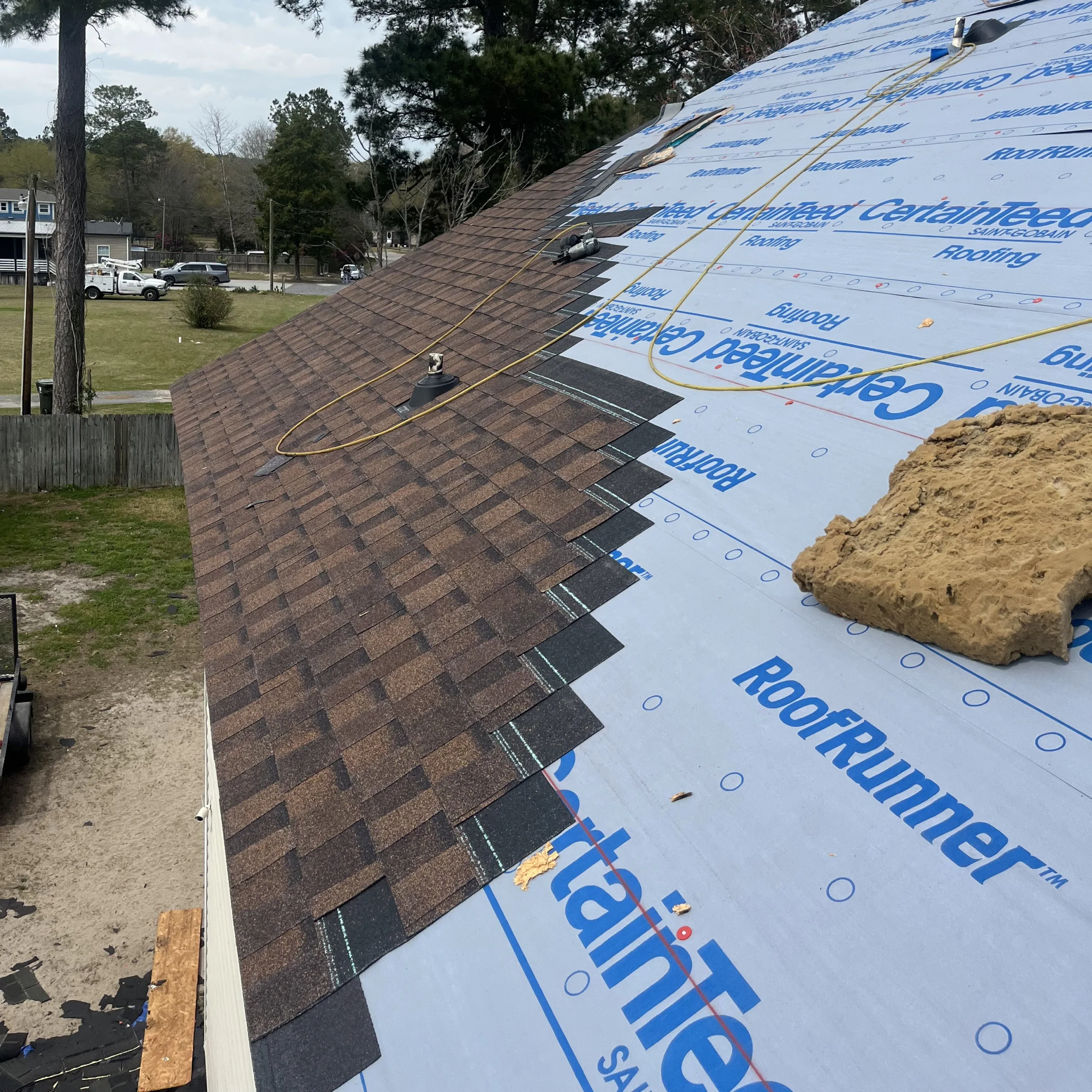 New roof replacement. Asphalt shingle installation. CertainTeed roof wrap installation